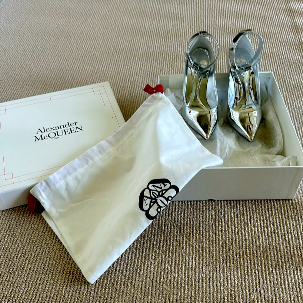Alexander McQueen Pumps feature a wide ankle strap and buckle closure.